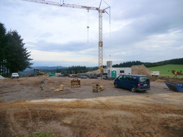 Foto der Baustelle, auf welcher ein großer Kran steht.